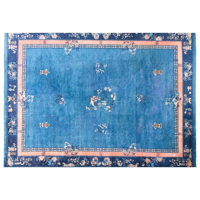 This early 20th-century Chinese Art Deco rug features a deep indigo field that draws you in immediately. Around it,...