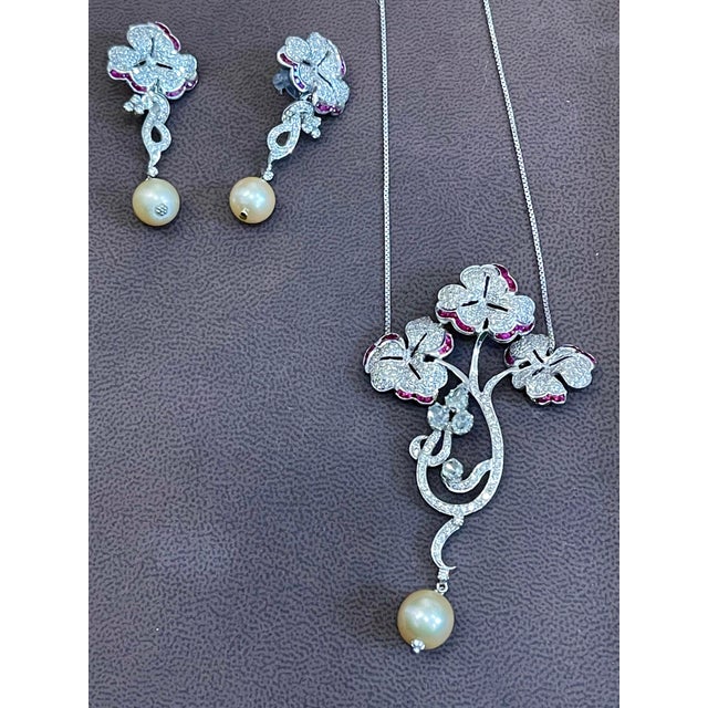 This Suite made out of 18 Karat white gold .It is consisting of 3 natural Pearls and Rubies . There are Invisible set...