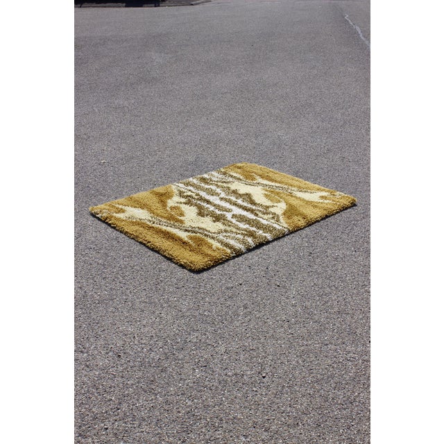 Wool rug with an abstract multicolored motif typical of the 1970s, by Junghans Germany. New old stock, has never been...