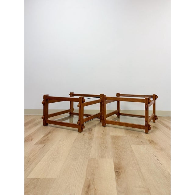 This pair of vintage teak side tables showcases traditional mortise and tenon joinery, a hallmark of quality wood...