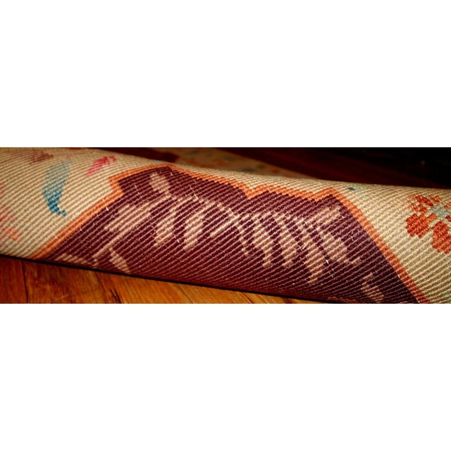 Wine burgundy Art Deco Chinese rug with beautiful light floral border. The rug is from the beginning of 20th century in...