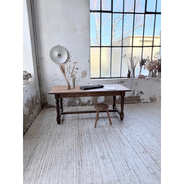 Antique small farmhouse table with turned legs and a central stretcher, made of pine and birch. We particularly love its...