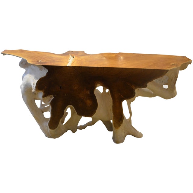 The flat sections of this beautiful teak wood console have been polished to enhance the natural reclaimed teak wood. The...