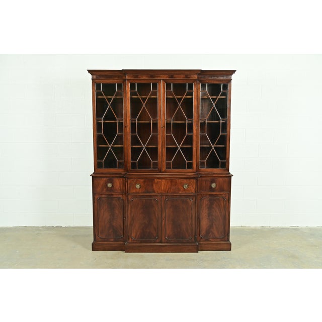 A gorgeous Georgian or Chippendale style breakfront bookcase or dining cabinet with drop front secretary desk In the...