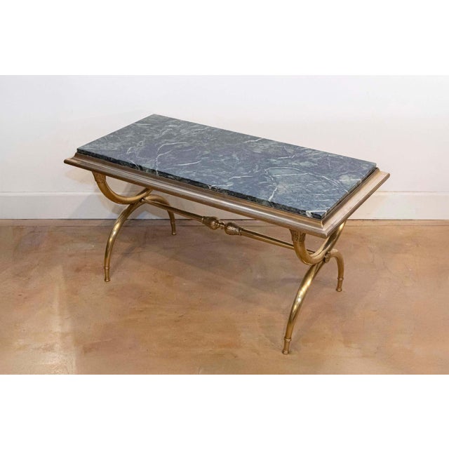 This exquisite 20th-century French coffee table is a stunning blend of opulent materials and elegant design, perfect for...