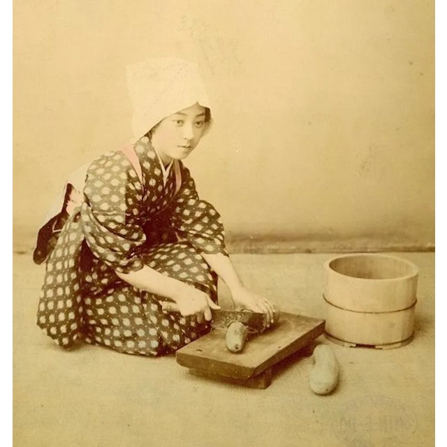 Japanese Woman Cooking by Shin E Do is an hand-inked Albumen print with aniline applied on hardcover. Very good...