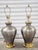 Very unique pair of vintage 1990's handcrafted silver metal table lamps with brass accents. The pair of lamps are...