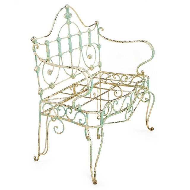 This antique wrought iron outdoor bench captivates with its elegant lines and delicate openwork design. A testament to...