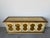 Vintage Hollywood Regency credenza featuring five decorative doors with gold accents and ornate metal pulls. Finished in a...