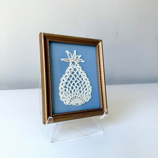 Vintage framed miniature framed crochet pineapple on carolina blue matting.