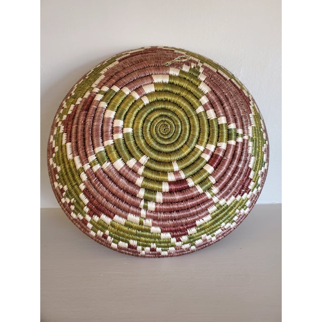 Handwoven vintage basket circa 1930s has a unique colorway that works with many design styles. Beautiful used as a piece...