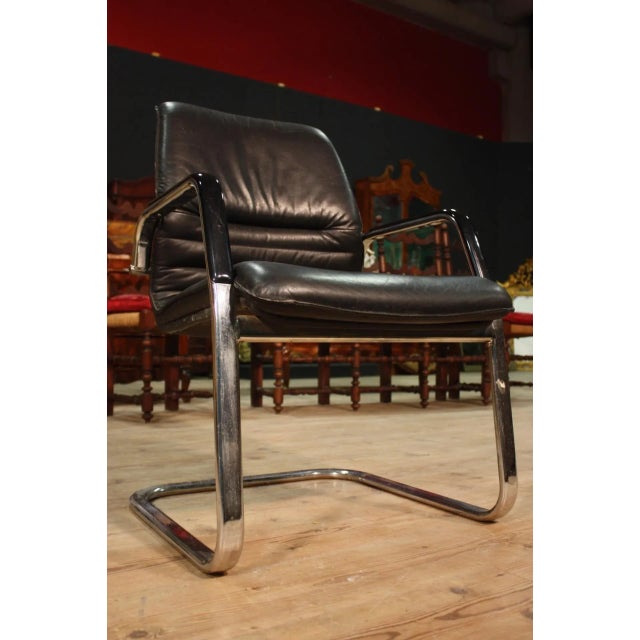 This desk or study armchair in iron features armrests in black plastic and a seat in faux leather.