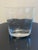This elegant clear glass vase features a contemporary design with a heavy, weighted base and subtly curved sides that...