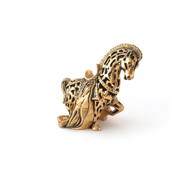 Here is a majestic Mid-Century ceramic sculpture of a horse. The horse is painted gold and black with multiple patterned...