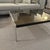 Minotti Smoked Glass Coffee Table Sleek and minimalist coffee table by Minotti featuring a smoked glass top and polished...
