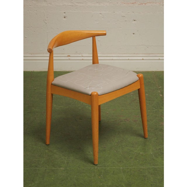 With its modern profile, natural wood legs, and stylish frame, this dining chair is sure to be an eye-catching piece for...