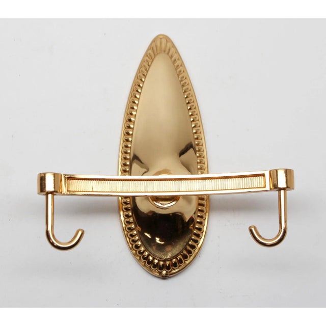 Brand new polished brass wall hook with a beaded back plate. Made by Sanistyl Creations in France. The exact date of...