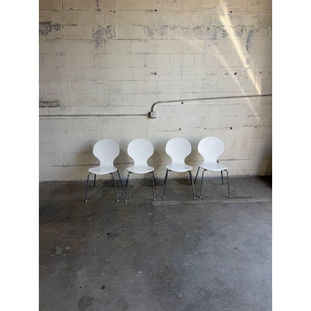 Beautiful set of 4 vintage Danish modern stacking chairs featuring sculptural white molded seats and sleek chrome legs....