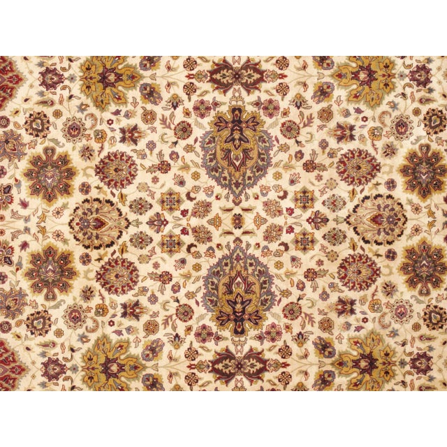 Add a beautiful contemporary style to your home with this Pasargad Tabriz Hand-knotted Yellow and Ivory Silk and Wool Rug....