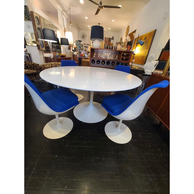 1960s Knoll 54" round Table and 4 chairs by Eero Saarinen with early Knoll labels. Chair backs have been reupholstered...