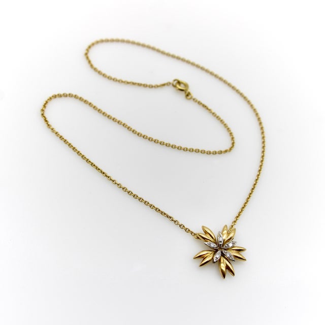 This stylized flower pendant has all the classic lines and nuances of Mid-Century Modern jewelry. The center is a five-...
