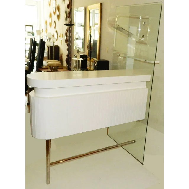 Circa the 1960s, this spectacular Italian bar is in the style of Gio Ponti, with a Fornasetti design on the sliding doors....