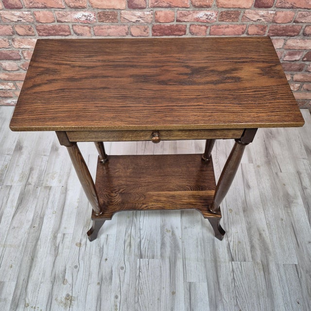 Elegant antique oak side table dating from the turn of the 20th century, circa 1890–1910, most likely around 1900. The...