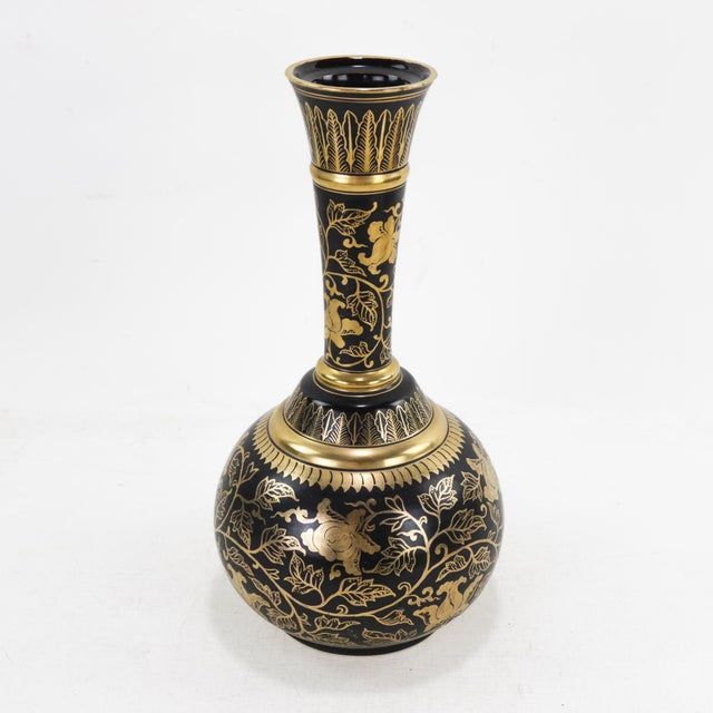 This exquisite lacquerware vase features a stunning black and gold floral design, meticulously handcrafted with intricate...