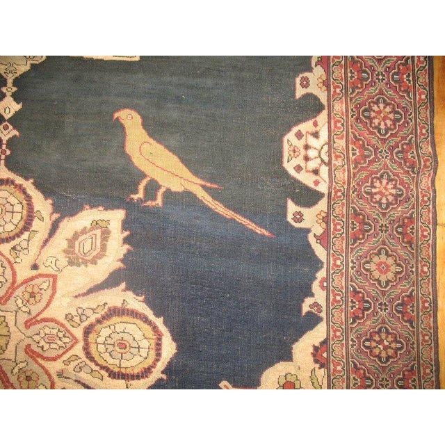 A long gallery size Karabagh rug with a pictorial piegoen design on a dark navy field. 7'2'' x 21'5''