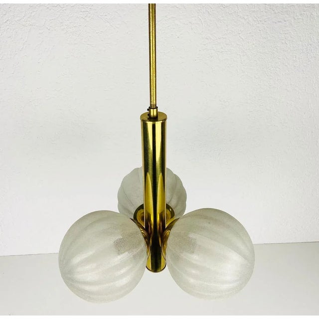 A midcentury kaiser chandelier made in germany in the 1960s. It is fascinating with its space age design and three opaline...