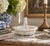 A charming circa 1980s white ceramic basket modeled in remarkably convincing trompe-l’oeil basketry. The open reticulated...