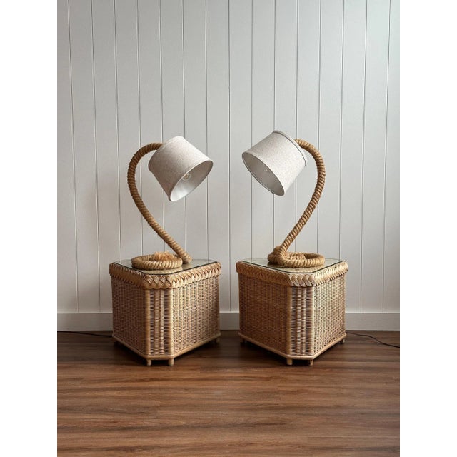 A sculptural pair of French mid-century table lamps formed from heavy rope with coiled bases, each finished with a white...