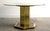 Substantial and beautifully made, this pedestal dining table pairs a faceted hexagonal column clad in polished brass with...