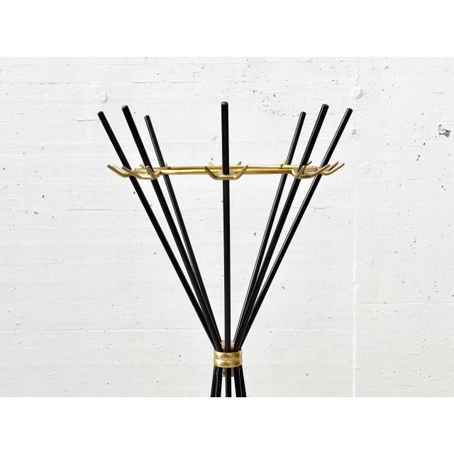 This Italian umbrella stand from the 1950s boasts a striking, sculptural form strongly reminiscent of Mid-Century Modern...