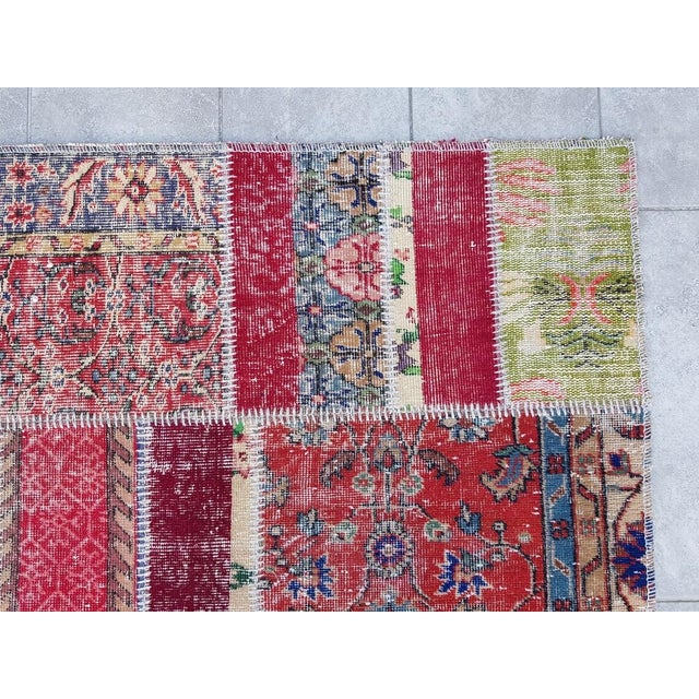 This is a vintage Turkish Oushak rug from the Mid 20th Century. The piece was hand-knotted.