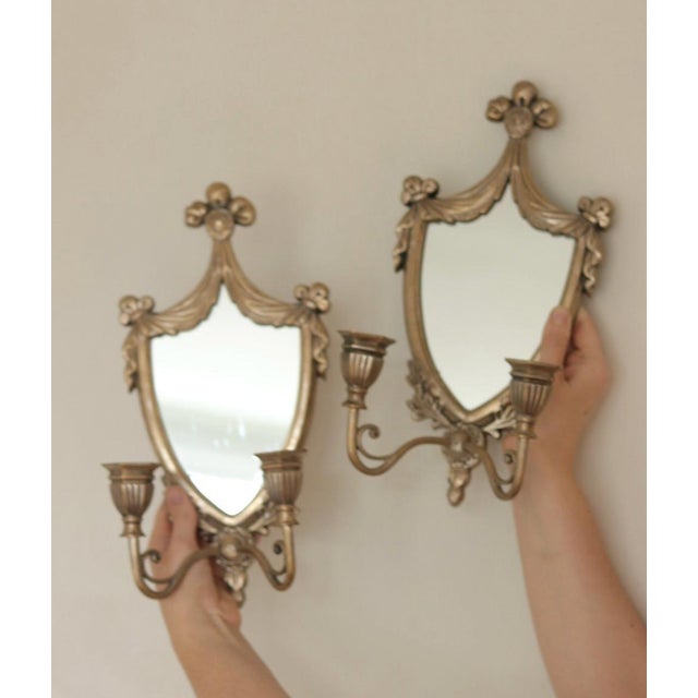 Two elegant double arm Italian candle wall sconces with mirrors, adorned with scroll detailing. These sconces are in good...