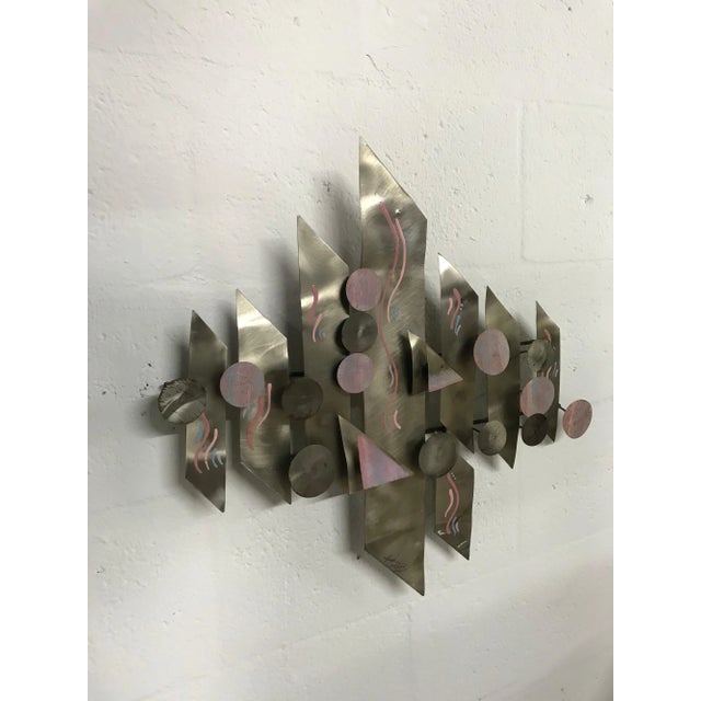 Aluminium and hand-painted wall sculpture signed by artist.