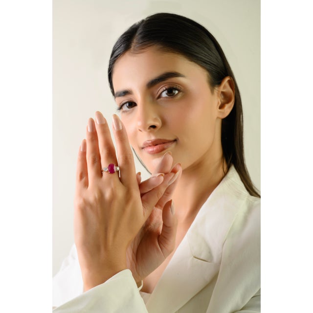This timeless three-stone ring feature 1 oval cut natural ruby weighing 3.19 carats, set in 14k yellow gold. The ruby...
