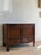 A handsome late 18th century English oak coffer, crafted with a restrained paneled front and fitted with an unusual lower...