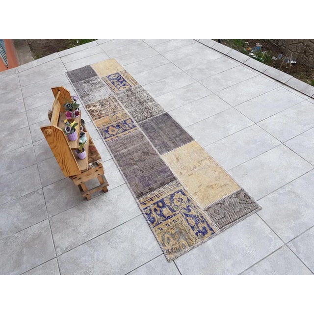 This is a vintage Turkish Oushak rug from the Mid 20th Century. The piece was hand-knotted.