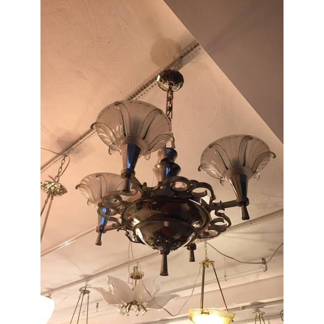Stunning French Art Deco chandelier with four Opalescent glass shades having clear and green color. The frame is beautiful...