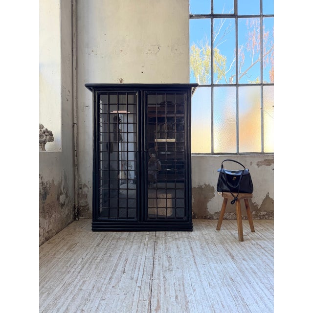 Antique 1900s bookcase in blackened rattan/bamboo with three glass sides. this display cabinet possesses a certain...