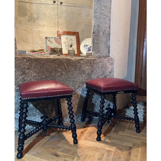 A striking pair of antique late 19th century english ebonized stools with twisted legs - also known as bobbin-turned or...