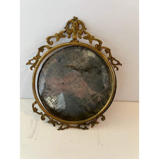 Vintage brass frame with easel back to stand up. Floral motif.