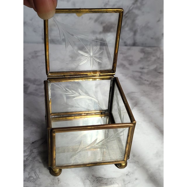 This is a beautiful etched glass and brass trinket box with a mirrored bottom inside. Would make a great display or...