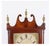 A mahogany pillar-and-scroll shelf clock with a broken-scroll pediment, three brass urn finials, slender turned columns,...