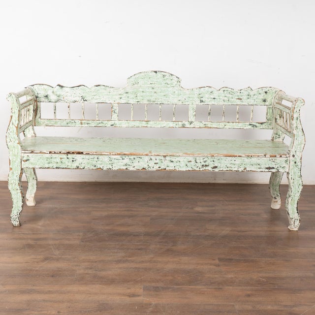 Rustic green painted pine bench from Hungary, perfect for an informal country look. The mint green and white layers of...