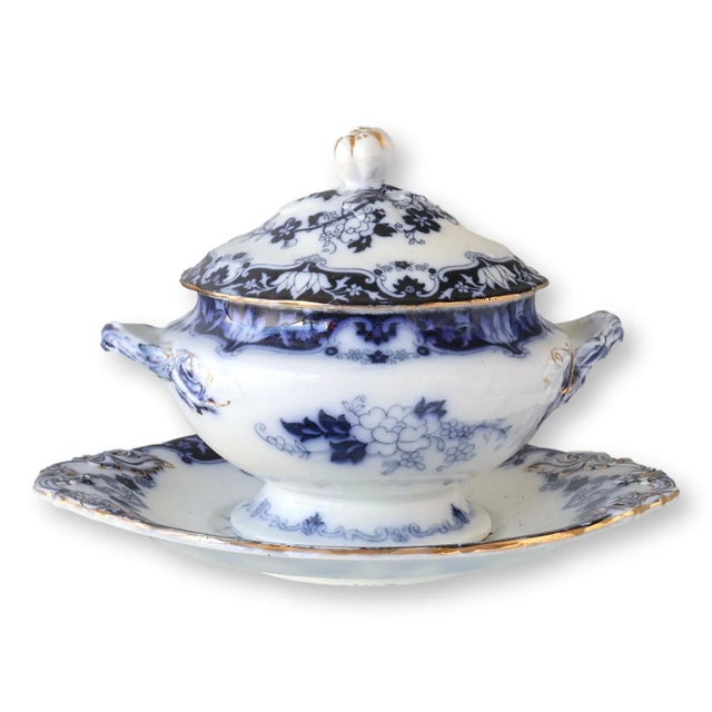 Antique English tureen with matching under tray, dating to circa 1880. This exquisite piece features an intricate blue...