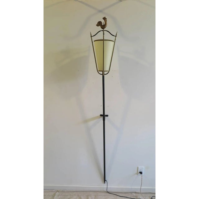 20th century iron and brass wall torchiere attributed to Jacques Adnet. Hand-forged iron with Roster finial. This lamp is...