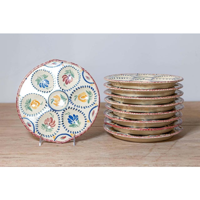 Eight French 19th century hand painted faïence oyster plates from Quimper from the HB manufacture presenting a floral...
